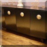 F17. Vintage black wood 4-door credenza with gold handles. 33”h x 66”w x 15”d 